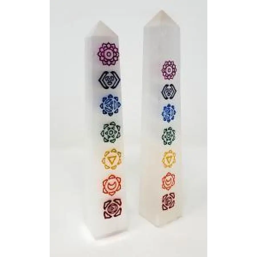 Hand-carved selenite obelisk with vibrant chakra stones arranged vertically, displayed on a white background. Perfect for cleansing, chakra alignment, and high-vibrational energy.
