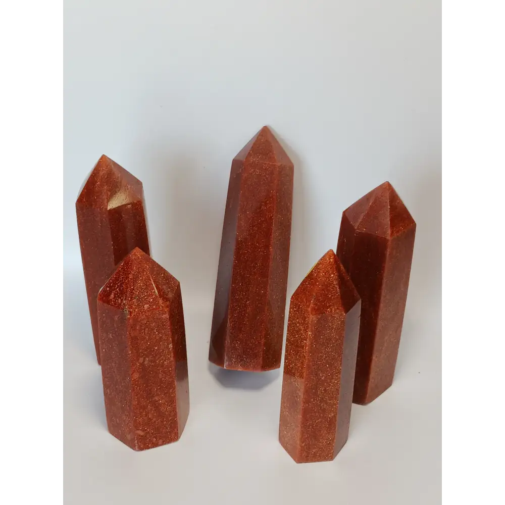 Hand-carved Goldstone tower featuring glittering copper sparkles and a glossy golden-brown finish, displayed on a white background.