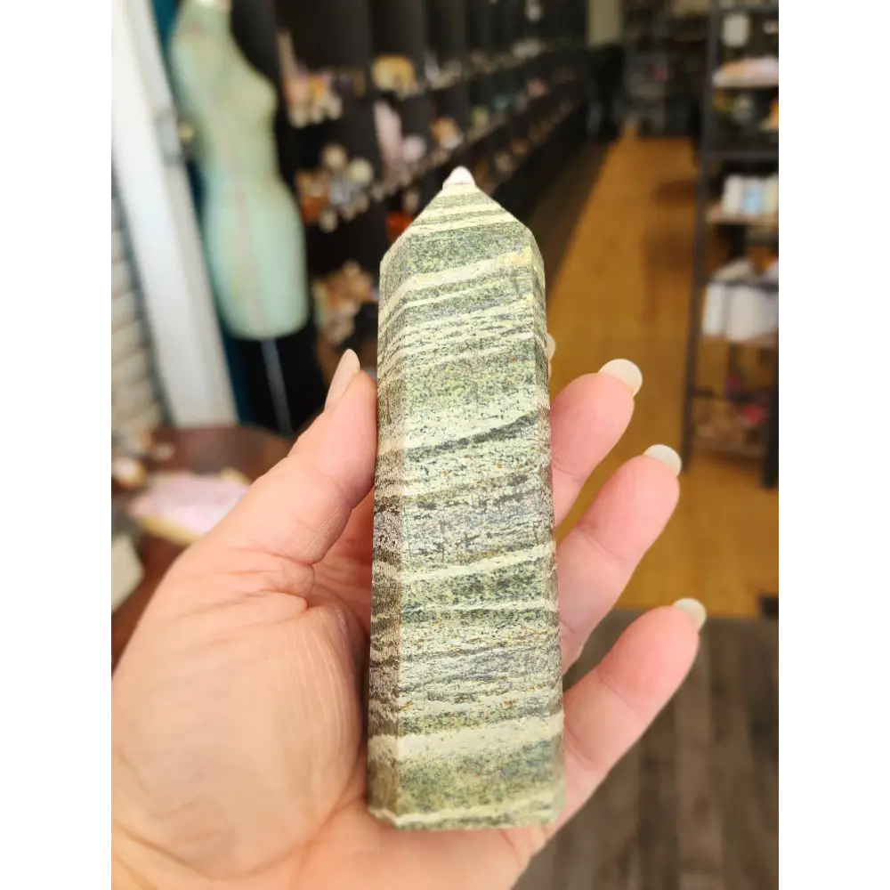 Hand-carved Green Zebra Jasper tower featuring bold green and white banded patterns, displayed on a white background.
