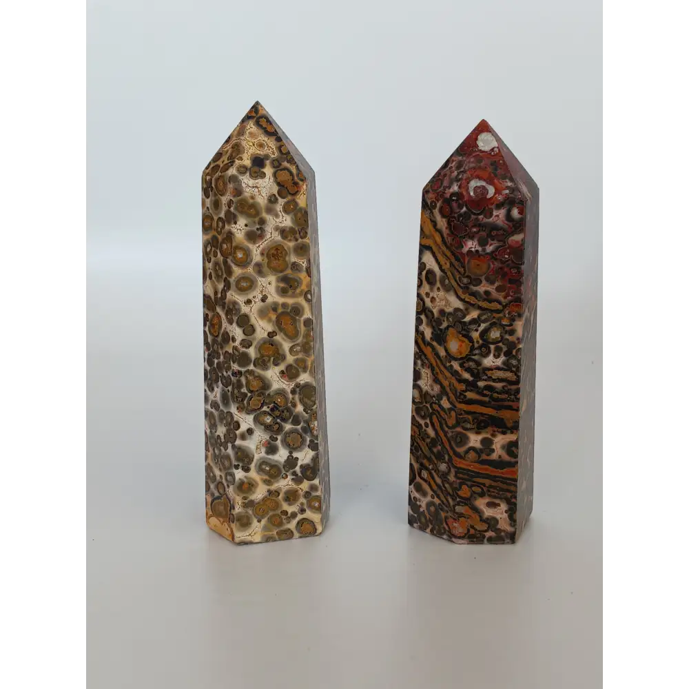 Hand-carved Leopard Jasper point featuring bold, earthy spotted patterns and a polished finish, displayed on a white background.