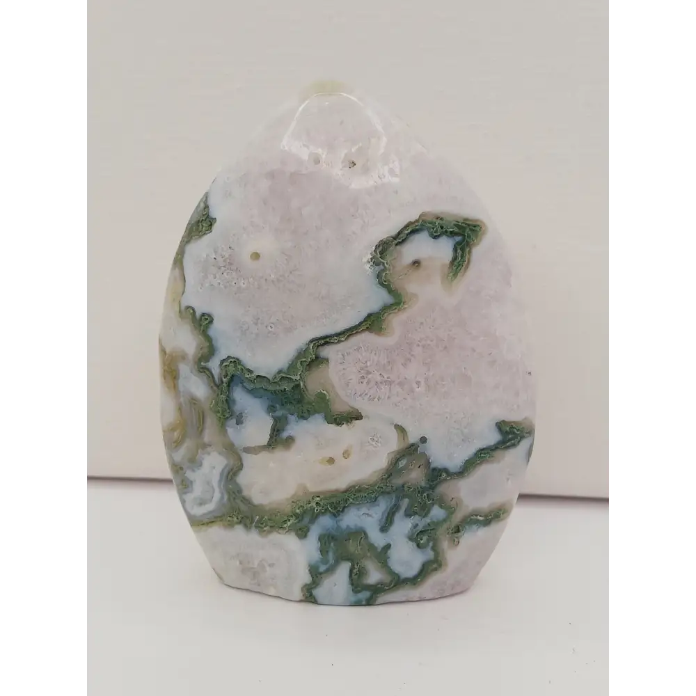 Moss Agate freeform, approx. 4 inches tall, with lush green and white patterns, displayed on a white background.