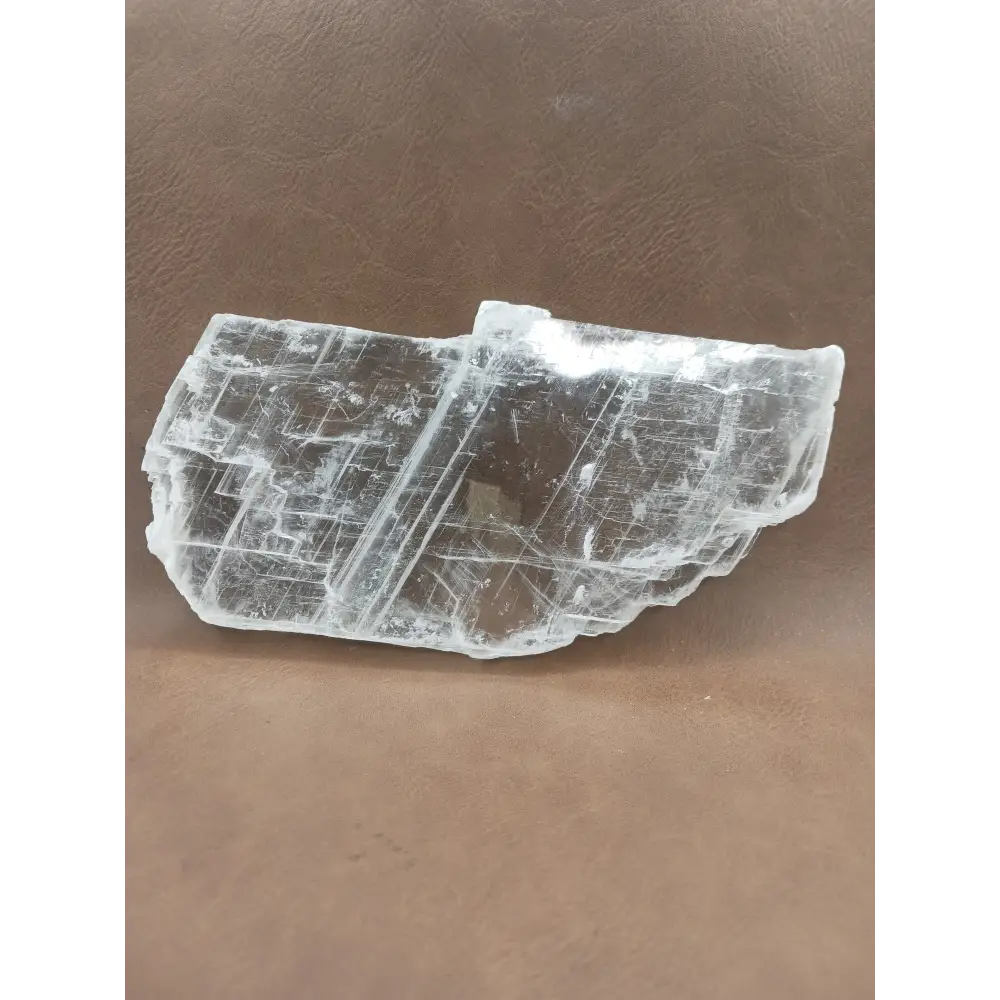 Pink selenite slab, polished with soft rosy hues, displayed on a white background.