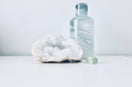 white geode beside clear bottle