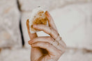 person holding bread with cheese