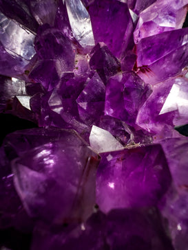 a bunch of purple crystals sitting on top of a table