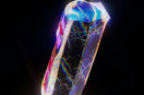 a very colorful diamond on a black background