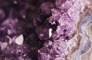 a close up of a rock with purple crystals