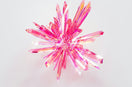 a close up of a pink object on a white surface