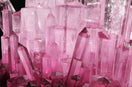 A pile of pink crystals sitting on top of a table