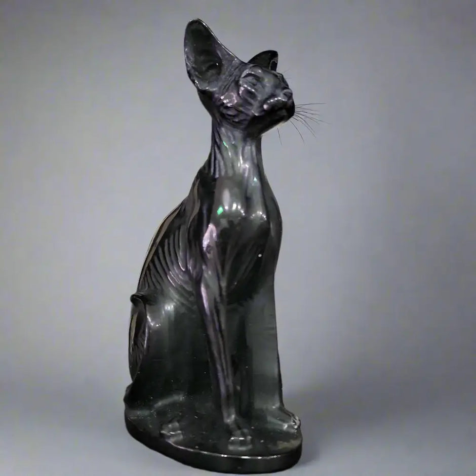Hand-carved 6-inch Egyptian Hairless Cat Bast statue featuring sleek, hairless lines and expressive detail, inspired by the goddess Bastet, displayed on a white background.

