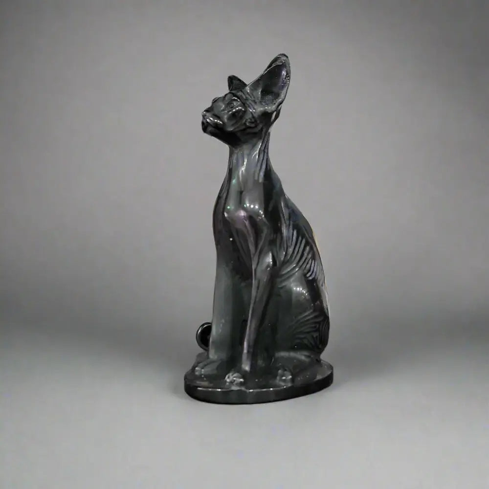 Hand-carved 6-inch Egyptian Hairless Cat Bast statue featuring sleek, hairless lines and expressive detail, inspired by the goddess Bastet, displayed on a white background.

