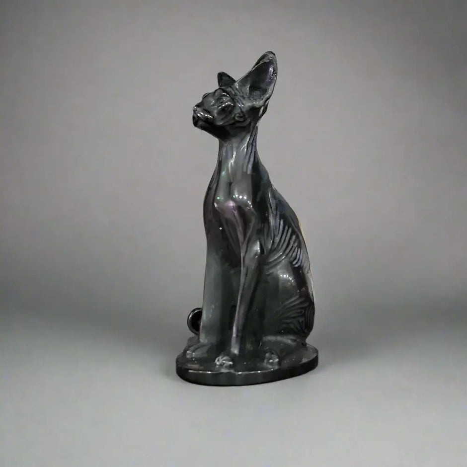 Hand-carved 6-inch Egyptian Hairless Cat Bast statue featuring sleek, hairless lines and expressive detail, inspired by the goddess Bastet, displayed on a white background.

