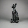 Hand-carved 6-inch Egyptian Hairless Cat Bast statue featuring sleek, hairless lines and expressive detail, inspired by the goddess Bastet, displayed on a white background.


