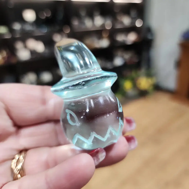 Aqua obsidian pumpkin carving with a witches hat, featuring vibrant blue hues and detailed craftsmanship, displayed on a white background. Perfect for Halloween decor and magical protection.