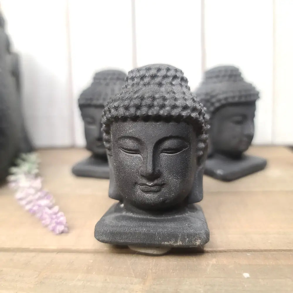 Hand-carved 2.5-inch Black Obsidian Buddha figurine with great detail, featuring serene facial features and intricate patterns, displayed on a white background.