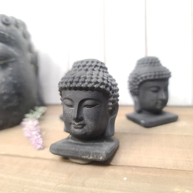 Hand-carved 2.5-inch Black Obsidian Buddha figurine with great detail, featuring serene facial features and intricate patterns, displayed on a white background.