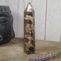 Hand-polished Black Septarian stone featuring bold yellow, brown, and black patterns, displayed on a white background.