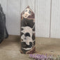 Hand-polished Black Septarian stone featuring bold yellow, brown, and black patterns, displayed on a white background.