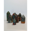 Hand-carved Bloodstone point, 2 to 2.5 inches tall, featuring deep green with natural red flecks, displayed on a white background.