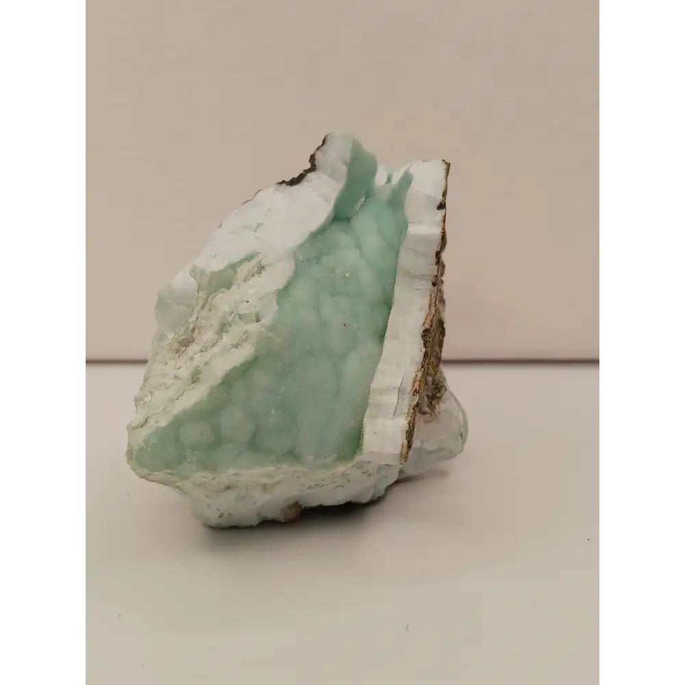 Natural Blue Aragonite specimen with tranquil blue hues and unique formations, displayed on a white background.