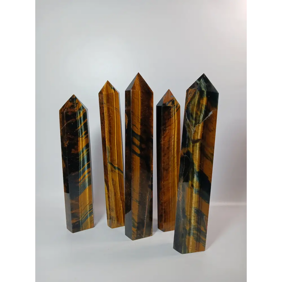 Hand-carved Blue Tigers Eye (Hawk’s Eye) tower with shimmering blue and gold bands, displayed on a white background.