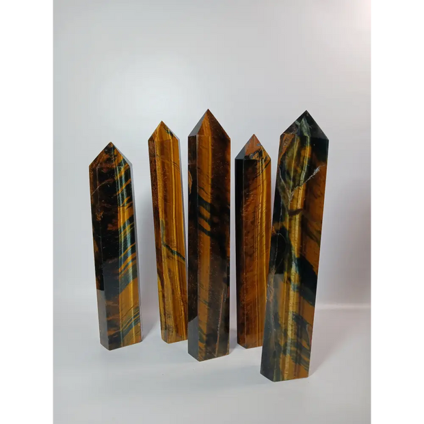 Hand-carved Blue Tigers Eye (Hawk’s Eye) tower with shimmering blue and gold bands, displayed on a white background.