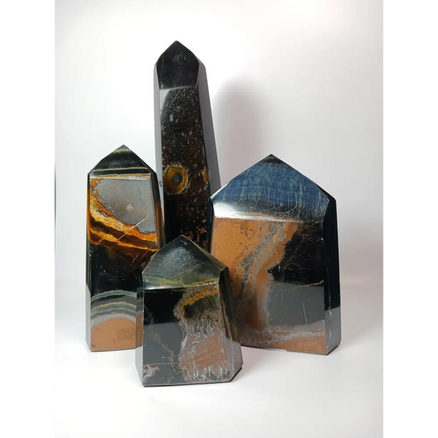 Hand-carved Blue Tigers Iron tower with bands of blue, gold, red, and metallic shimmer, displayed on a white background.