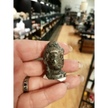 Hand-carved 1 1/2 inch tall Buddha head figurines in assorted crystal materials such as amethyst, rose quartz, clear quartz, and jade, displayed on a white background.