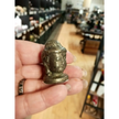 Hand-carved 1 1/2 inch tall Buddha head figurines in assorted crystal materials such as amethyst, rose quartz, clear quartz, and jade, displayed on a white background.