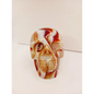 Carnelian skull with vibrant orange-red hues and natural banding, carved and displayed on a white background.