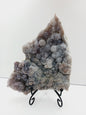 Fine glittery amethyst specimen, featuring sparkling purple points and a shimmering surface, displayed on a white background.