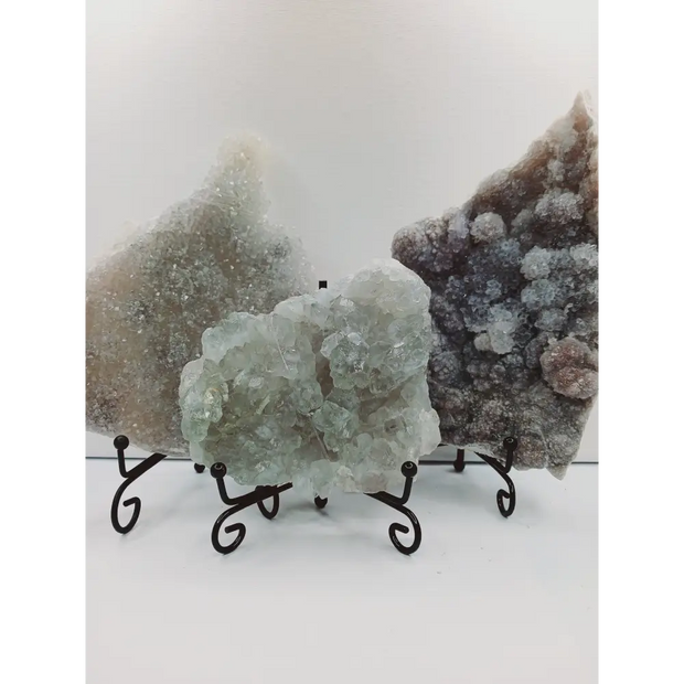 Fine glittery amethyst specimen, featuring sparkling purple points and a shimmering surface, displayed on a white background.