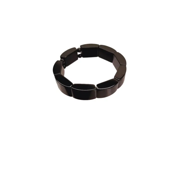 Black bracelet on a clear stand against a white background
