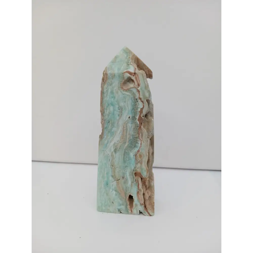 Hand-carved Gemy Hemimorphite tower with sparkling blue hues, displayed on a white background.