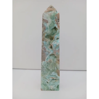 Hand-carved Gemy Hemimorphite tower with sparkling blue hues, displayed on a white background.
