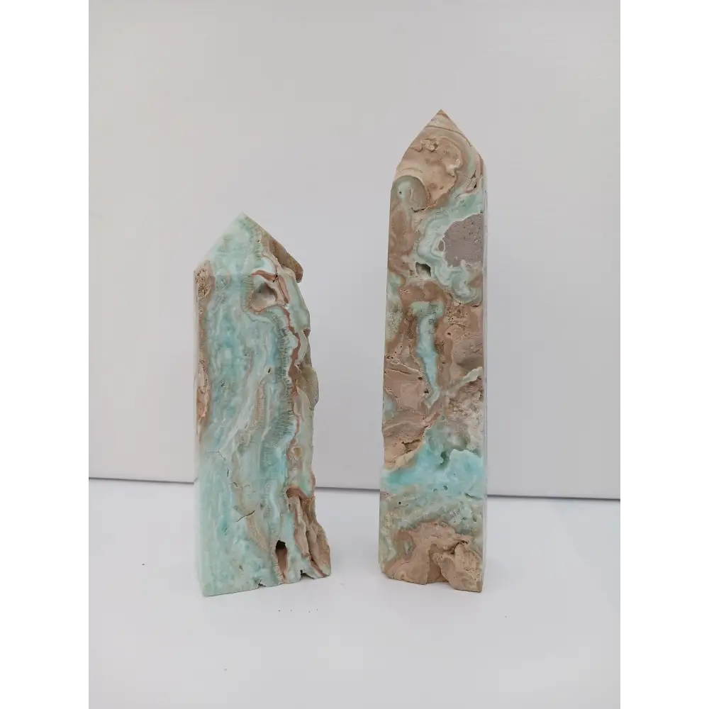 Hand-carved Gemy Hemimorphite tower with sparkling blue hues, displayed on a white background.
