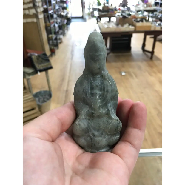 Hand-carved Goddess Guanyin statue made from genuine labradorite, featuring iridescent flashes of blue, green, and gold, displayed upright on a white background.