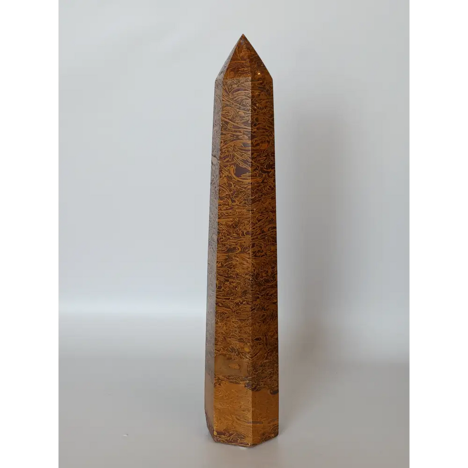 Hand-carved Golden Silk Jade tower featuring shimmering golden threads and a glossy finish, displayed on a white background.