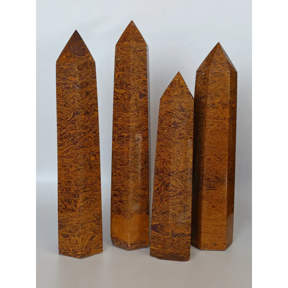 Hand-carved Golden Silk Jade tower featuring shimmering golden threads and a glossy finish, displayed on a white background.