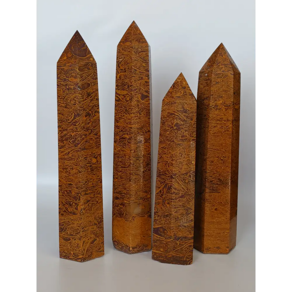 Hand-carved Golden Silk Jade tower featuring shimmering golden threads and a glossy finish, displayed on a white background.