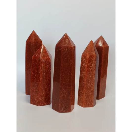 Hand-carved Goldstone tower featuring glittering copper sparkles and a glossy golden-brown finish, displayed on a white background.