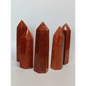 Hand-carved Goldstone tower featuring glittering copper sparkles and a glossy golden-brown finish, displayed on a white background.