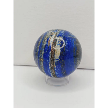 Marble-like sphere with blue and white patterns on a white background