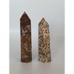 Hand-carved Leopard Jasper point featuring bold, earthy spotted patterns and a polished finish, displayed on a white background.