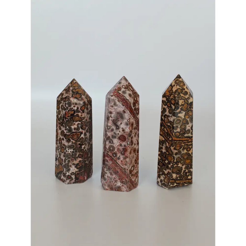 Hand-carved Leopard Jasper point featuring bold, earthy spotted patterns and a polished finish, displayed on a white background.