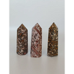 Hand-carved Leopard Jasper point featuring bold, earthy spotted patterns and a polished finish, displayed on a white background.
