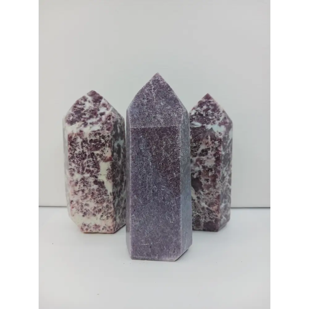 Hand-carved Lepidolite tower with soft lavender hues and natural shimmer, displayed on a white background.