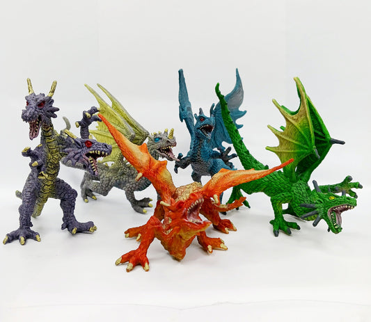 Set of colorful dragon figurines on a white background