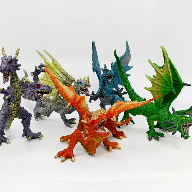 Set of colorful dragon figurines on a white background