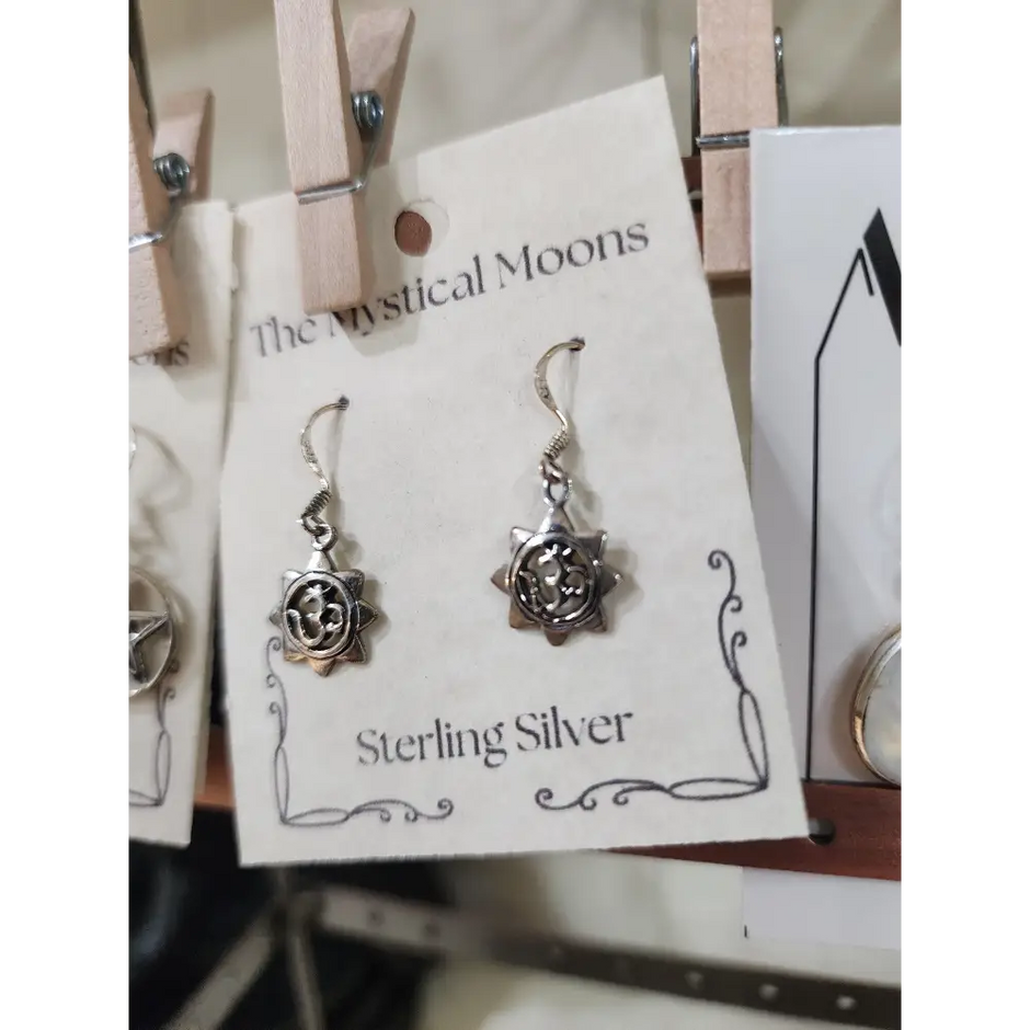 Sterling silver earrings featuring a radiant sun with the Om symbol at the center, displayed on a white background. Perfect for spiritual radiance, peace, and sacred style.
